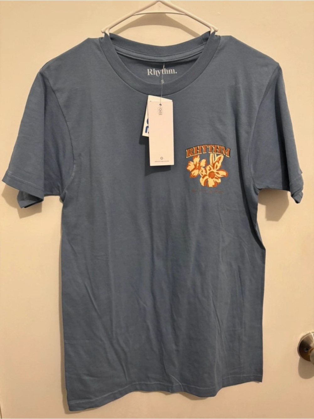 Rhythm. Men's Dusty Blue Tee with Orange Floral Logo